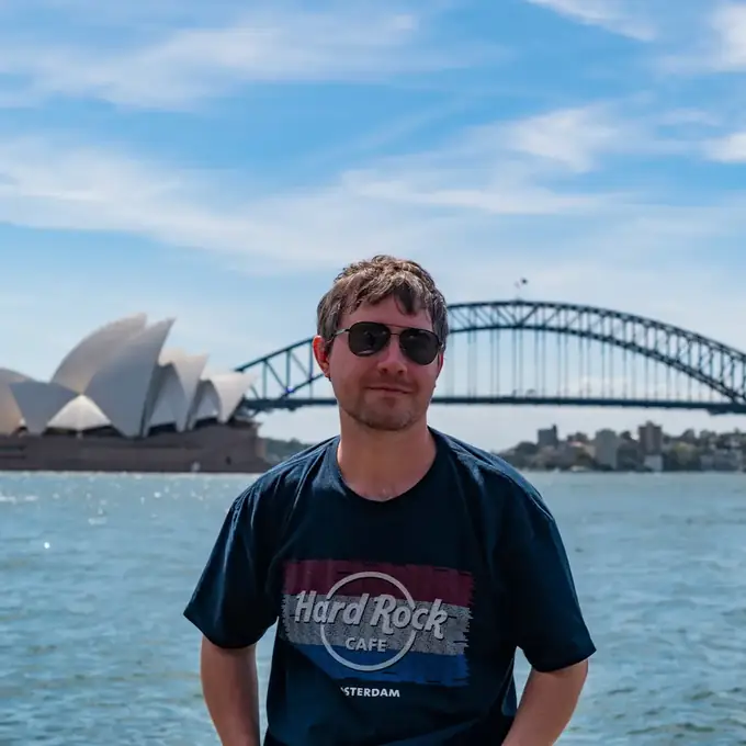 Luka Varga in front of the Sydney Opera House and Harbour Bridge
